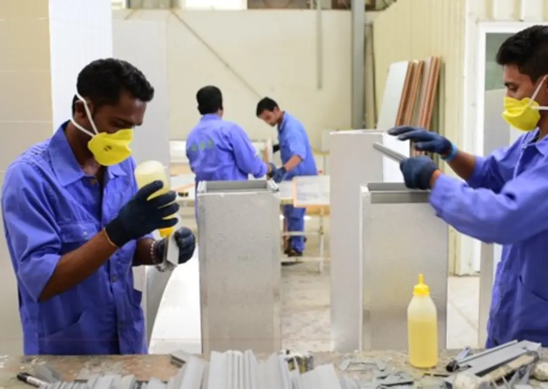 Mecamac fabricators closing and sealing pre-insulated duct sections at the Al Misfah workshop in Muscat