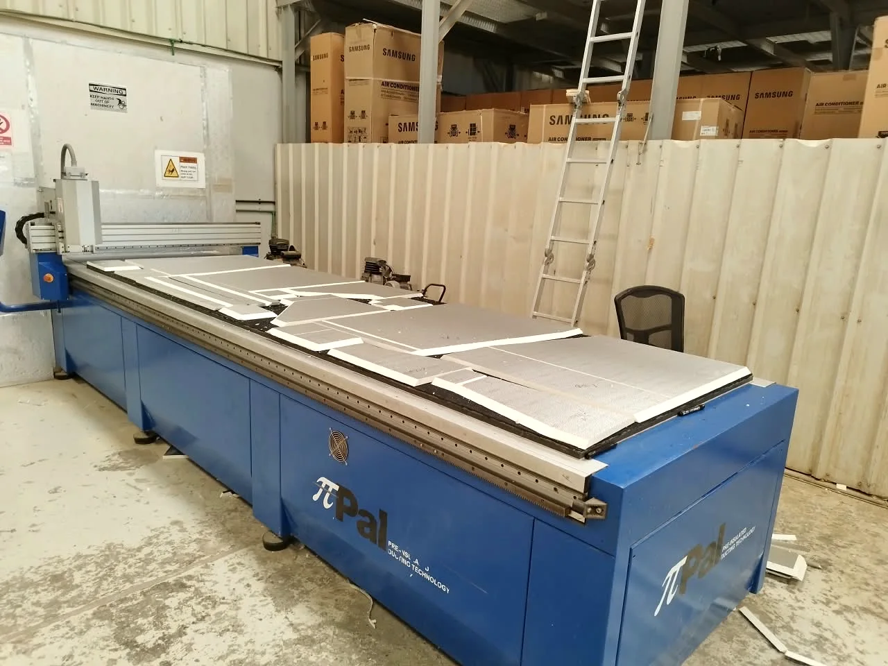 Pre-insulated panels cut and laid out on the PiPal CNC table at the Mecamac facility