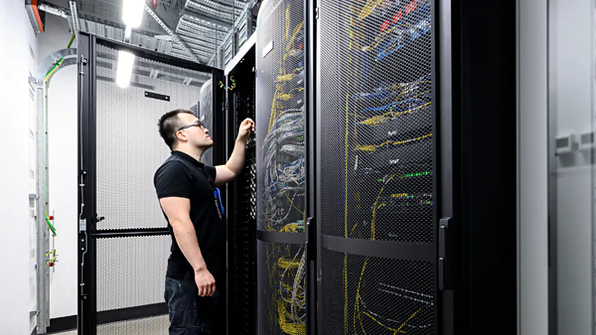 Engineer working on live rack infrastructure in a Mecamac data centre project