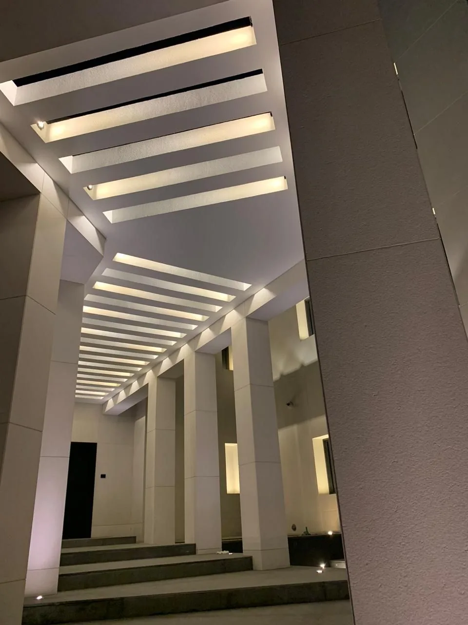 Entrance pergola with linear lighting in the beams — private villa, Muscat