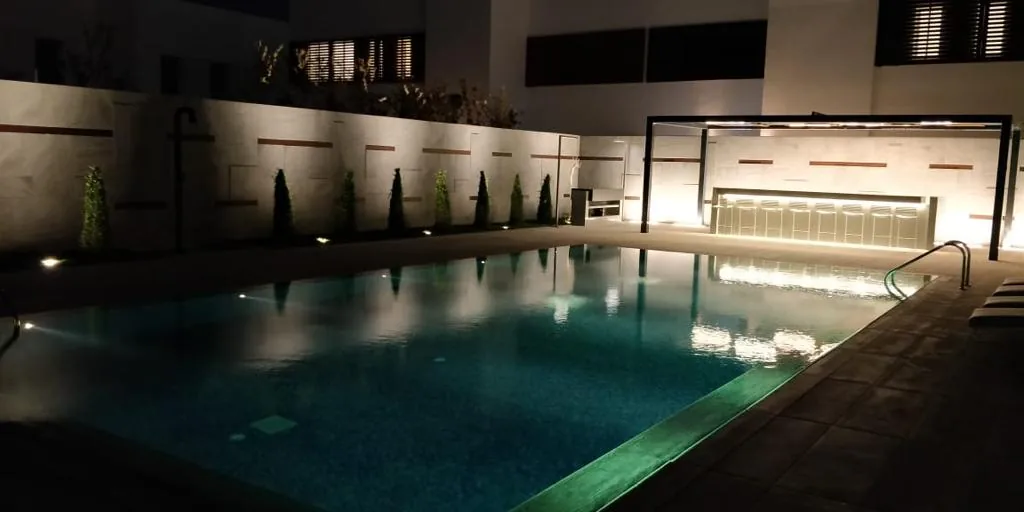 Pool and terrace lighting at night — private villa, Muscat