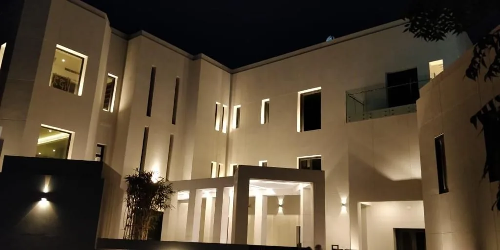Villa façade lit at night with recessed and linear fittings — private villa, Muscat